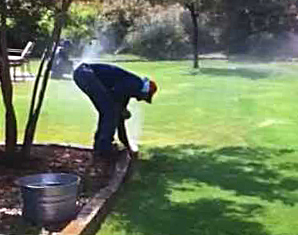 a professional tech is fixing a broken sprinkler
